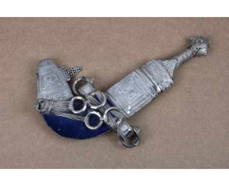 An early 20th century Omani Khanjar dagger, steel blade (showing rust), waisted horn hilt with all-over silver mounts, decora