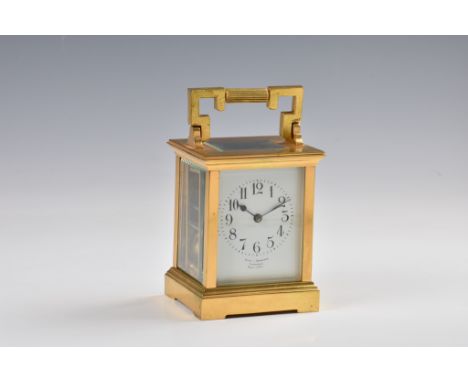 A French gilt brass carriage clock, c.1900, the white enamel Arabic dial signed 'Snow &amp; Ashworth Harrogate Made in Paris'
