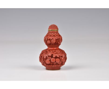 A Chinese carved cinnabar lacquer double gourd snuff bottle, the base with incised Qianlong seal mark, probably 19th century,