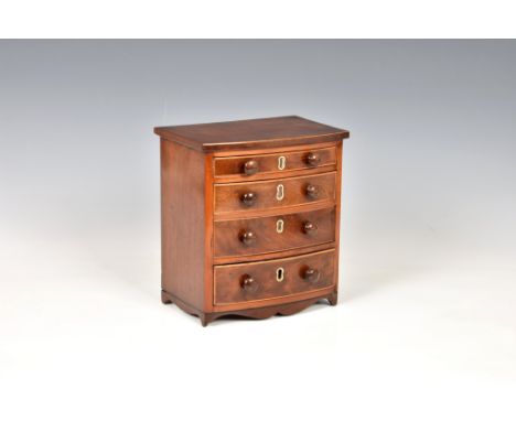 A mid-19th century apprentice piece miniature bowfront mahogany chest of drawers, made by the Master Carpenter Nicolas Martin