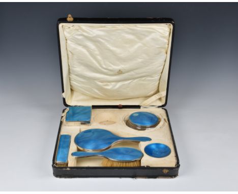 A cased George V silver and guilloche enamel dressing table set, Henry Clifford Davis, Birm. 1924, comprising a hand mirror, 