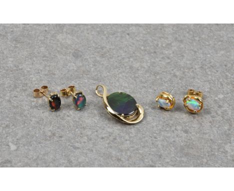 An 18ct yellow gold and black opal triplet pendant, 25mm. long; together with a pair of 9ct gold and opal triplet stud earrin