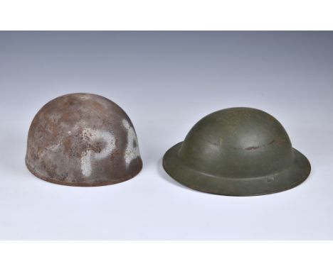 An American army steel helmet, and a British Brodie helmet. (2)  Both with wear and signs of rust etc.