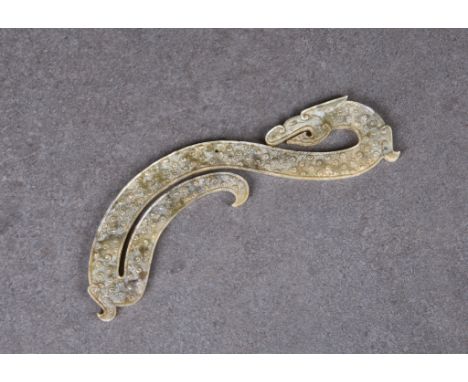 A Chinese jade dragon form pendant, Han Dynasty style, carved in the form of a long bodied dragon, with comma spirals decorat