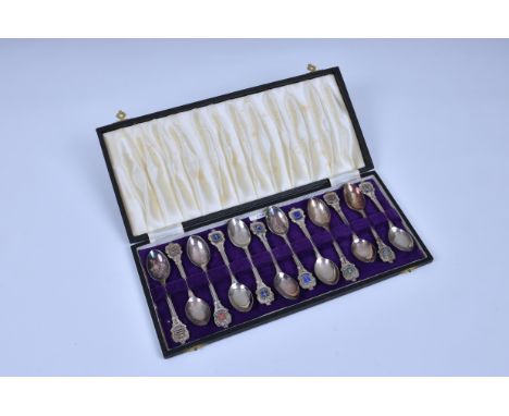 A cased set of twelve silver plate Jersey Parish spoons, each having enamel Parish shield finials.. * 