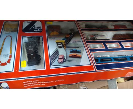Lima BR goods set, triang locomotives, tender and two coaches; track and lineside buildings. 