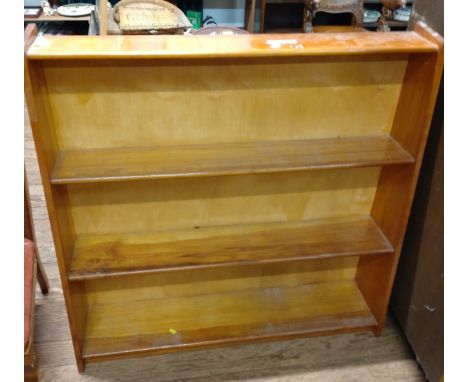 A small bookcase, each shelf gradually larger in depth towards the bottom. Approx. 90cm x 92cm x 23cm 