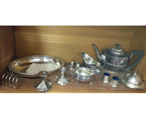 A collection of silver-plate including a candlestick, two pill boxes and a round stand. 