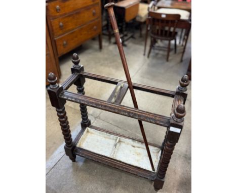 A Victorian oak bobbin turned stick stand and a walking cane 