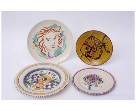 Group of four Poole plates variously decorated with the ZY pattern, a bouquet, deer and a fish designs, (4) 