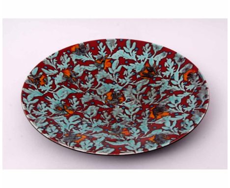 Large Poole Pottery charger with a blue floral design on red ground, 41cms diam, factory mark and monogram to base 