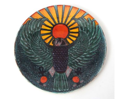 Poole Pottery Studio charger by Nicole Massarella, painted in green with a falcon with outstretched wings against a sunburst 