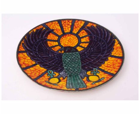 Poole Pottery Studio charger by Nicole Massarella, decorated with a falcon holding two orbs on an orange stippled ground, 34c