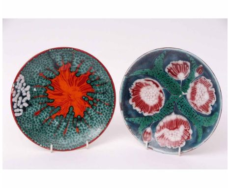 Two Poole plates, one with a floral design, the other an abstract design, both signed to the base by SM Pottinger, 20cms diam