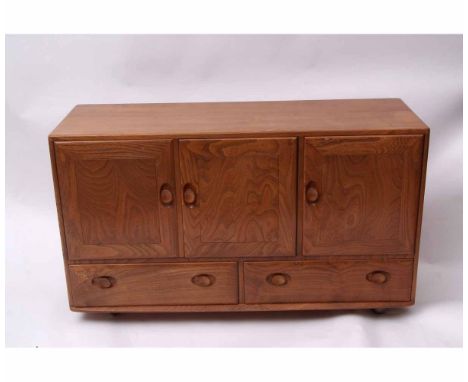 Ercol light elm sideboard, three doors over two drawers, 130cms wide  