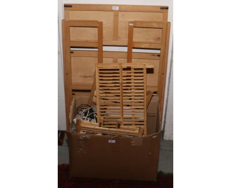 A large wooden shelving unit along with a box of wooden table top stands, lighting etc.