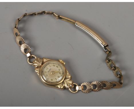 A ladies Rotary 9ct gold manual watch head on gold plated bracelet strap with Arabic numeral markers.