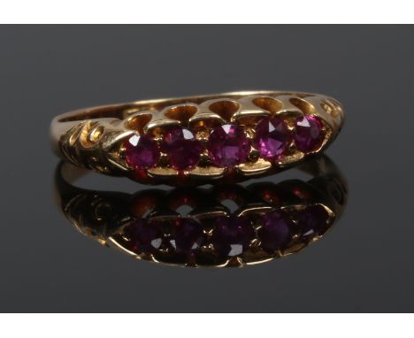 A Victorian gold five stone ruby ring in a boat shaped setting, size N.