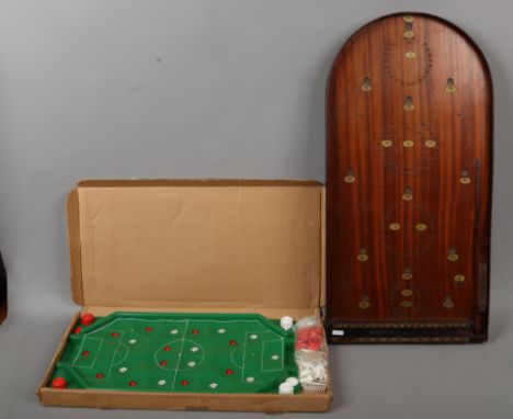 A bagatelle board with balls along with a vintage Bobby Charlton Casdon football game.