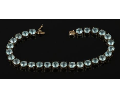 A 9ct gold tennis bracelet set with coloured paste stones, gross weight 10.88 grams.