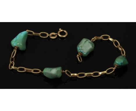 An 18ct gold bracelet with alternating textured and plain links interspersed with natural turquoise pebbles.