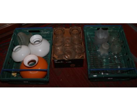 Three boxes of glass lamp shades and chimneys.