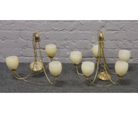 A brass five arm ceiling light along with a matching three arm ceiling light.