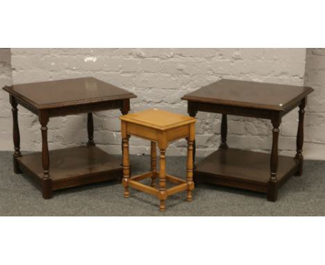 A pair of carved oak lamp tables along with a small oak occasional table.