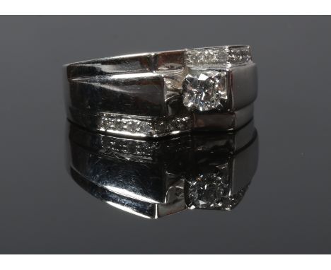A 9ct white gold modernist ring set with a brilliant cut diamond,&nbsp; 0.55ct clarity I1 colour H, set with two rows of diam