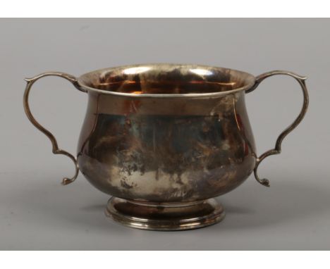 A George V silver twin handled sugar bowl by W. Hutton, assayed Birmingham 1938, 98 grams,