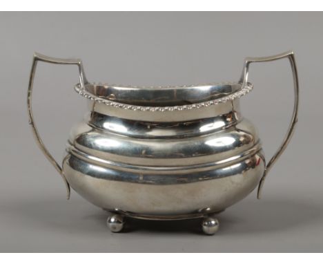 A George V silver twin handled sugar bowl by W. Hutton &amp; Sons, assayed Sheffield 1939, 185 grams.