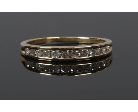 A boxed 18ct gold and diamond eternity ring set with approximately 0.25ct of diamonds, size L 1.95 grams gross weight