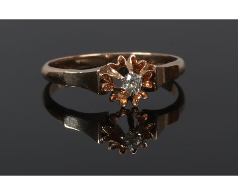 A rose gold and diamond solitaire ring in flower head setting, stone approximately .064ct size O1/2.