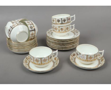 A collection of bone china teawares with gilt floral borders, saucers marked 1250 to base, 26 pieces.