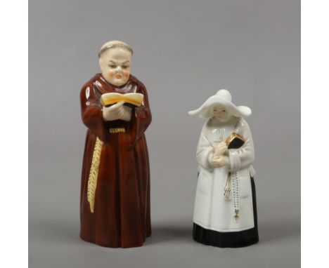 Two Royal Worcester candle snuffers, one formed as a monk the other a nun.