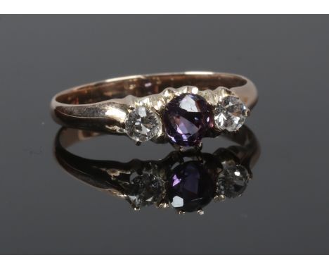 A gold ring set with coloured and white paste stones, acid tested no marks, size L.