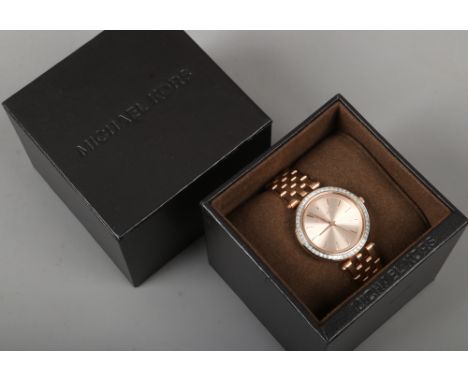 A boxed ladies Michael Kors rose gold coloured stainless steel quartz wristwatch.Condition report intended as a guide only.Ru
