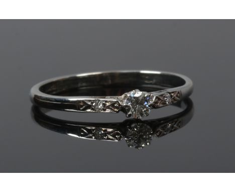 An 18ct white gold ring set with a brilliant cut diamond approximately 0.1ct and with diamond set shoulders, size O.