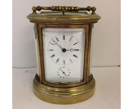 French oval gilt brass four pane carriage clock, striking on a bell with key. Losses to glass fron see photos