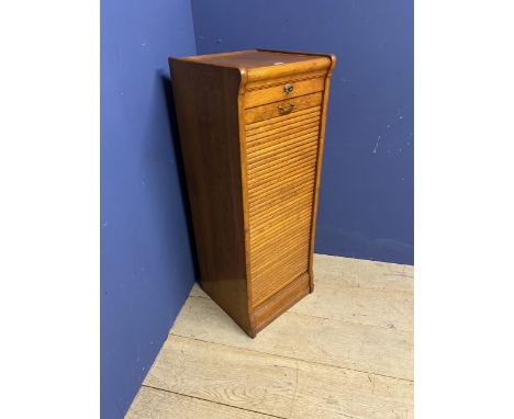 A vintage honey coloured oak tambour fronted cabinet 