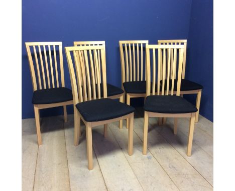 A set of 6 modern light coloured chairs with black seats 