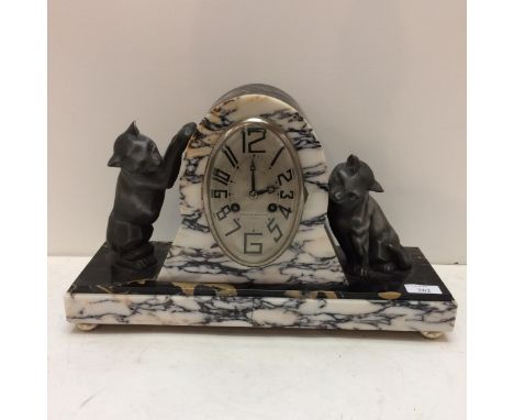 A French slate and marble mantle clock, in the Art Deco taste, the oval dial marked 108-110 Rue Gambetta, Lille, and a pair o