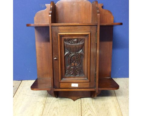 Mahogany hanging cupboard, with raised carved floral panel to front 