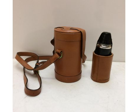 A modern light tan leather hip flask with shoulder strap, the top opening to reveal 3 fitted glass bottles 