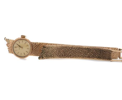 LADY'S OMEGA NINE CARAT GOLD MANUAL WIND WRIST WATCH,the round cream dial with applied baton hour markers, 17mm case, on a pa