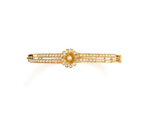 GOLD, HALF-PEARL AND DIAMOND BANGLE, 1890s the hinged bangle centring on a daisy motif set with rose-cut diamonds, to shoulde