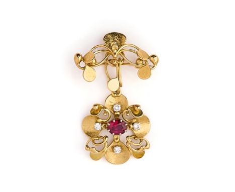 VALERIE PITCHFORD: GOLD, RUBY AND DIAMOND BROOCH/PENDANT, 1986 the gold brooch of textured scrolling leaf design supporting a