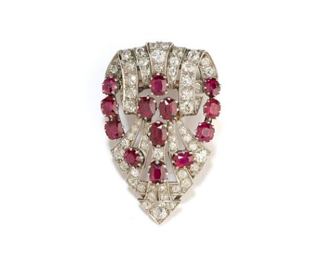 RUBY AND DIAMOND CLIP / BROOCH, 1930s of open work geometric palmette design, set with circular-cut diamonds accented with ov