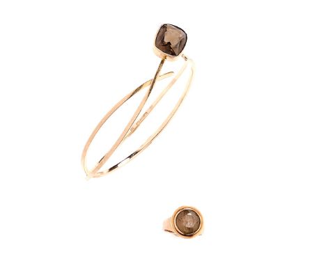 □ SMOKY QUARTZ RING AND BANGLE, 1970s the bangle of open work wire design, terminating in a collet set cushion-shaped smokey 