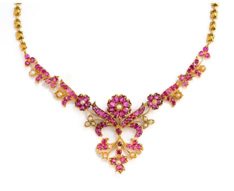 GOLD, RUBY AND SEED-PEARL NECKLACE, 1890sfoliate design set with mixed-cut rubies and seed-pearls, to a quatrefoil link chain